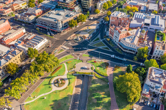Aerial view of a city with a park near a busy intersection