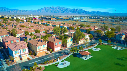 Aerial Suburban Oasis with Desert Landscape and Mountain View