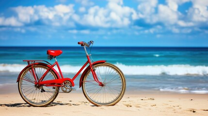 A red sightseeing bike with a sturdy frame resting on a sandy beach with ocean waves behind