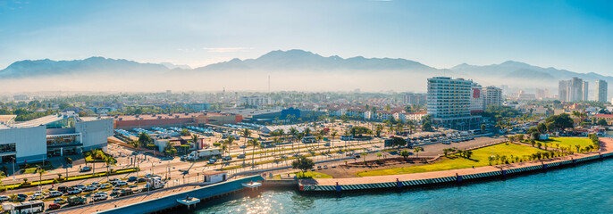Obraz premium A view from the Cruise terminal inland towards mountains in Puerto Vallarta in early springtime
