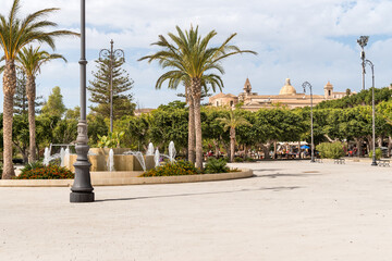 Garden of the Villa Comunale, with the fountain and palm trees, in the historic center of Noto, province of Syracuse, Sicily, Italy