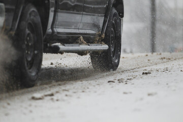 Truck tires driving down a snow covered road.