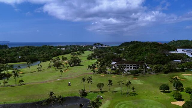 Aerial View of a Tropical Golf Course with Ocean and Green Landscape