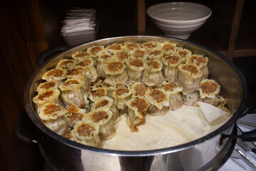 Line traditional chinese food gourmet or local cuisine meal buffet breakfast stuffed dumpling wheat dough enclosing minced meat and steamed for travelers guests use taste eat tasty in Hubei, China