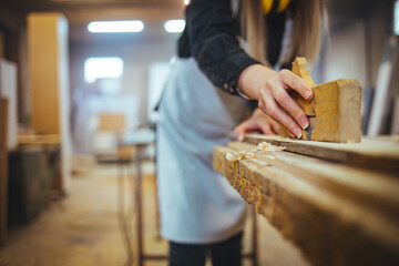 Closeup of Carpenter Working With Wood Plane on Wooden Surface in Workshop