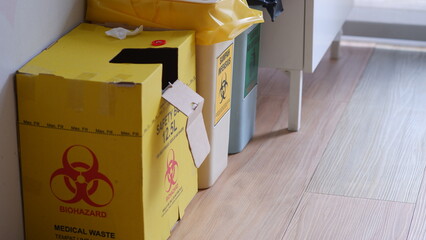 Yellow Disposal Safe box for sharp and clinical waste in a medical clininc.