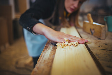 Craftsman Sanding Wood Surface in Workshop With Precision and Care