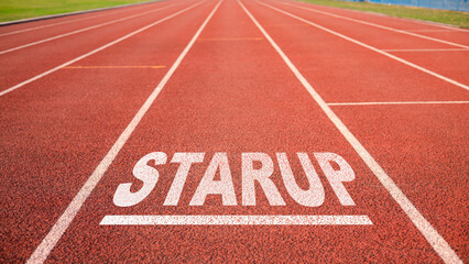 Startup Business Concept, Present on Start Line in Running Track at Arena Stadium, Startup written on running track, It says on the treadmill along the white line.