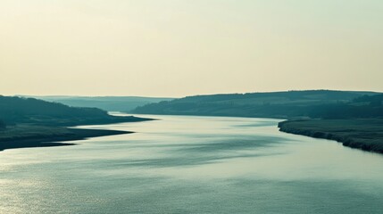 Serene River View with Lush Green Banks and Gentle Ripples under Soft Blue Sky