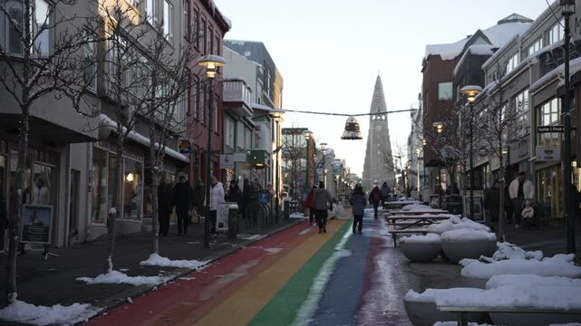 View of shops on Skolavoroustigur Rainbow Street and Hallgrimskirkja church in background in winter, Reykjavik, Iceland