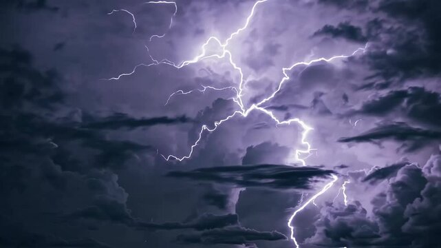 Electrifying night sky: intense lightning storm illuminates dark clouds in dramatic display