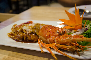 Stir fried mini lobster with tamarind XO sauce served on ceramic dish