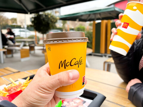 Enjoying McCafe Coffee and Refreshing Drinks at Outdoor Cafe with Friends in a Relaxed Atmosphere, socializing concept