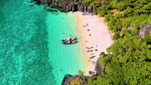 Aerial drone landscape bay turquoise lagoon Nui beach with long tail boat koh Phi Phi Don island Krabi Thailand