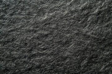 Dark textured stone surface with subtle light play. Neural network AI generated