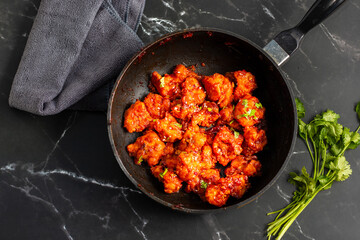 Gobi Manchurian is a crispy, spicy Indo-Chinese dish made with battered, fried cauliflower tossed in a tangy, flavorful soy-garlic sauce.