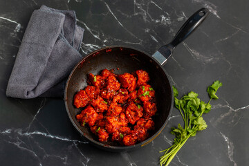 Gobi Manchurian is a crispy, spicy Indo-Chinese dish made with battered, fried cauliflower tossed in a tangy, flavorful soy-garlic sauce.