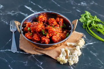 Gobi Manchurian is a crispy, spicy Indo-Chinese dish made with battered, fried cauliflower tossed in a tangy, flavorful soy-garlic sauce.