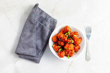 Gobi Manchurian is a crispy, spicy Indo-Chinese dish made with battered, fried cauliflower tossed in a tangy, flavorful soy-garlic sauce.