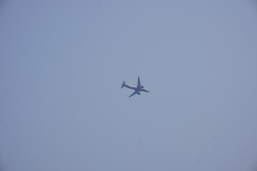 A domestic flight is flying in the clear blue sky 