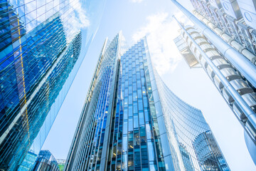 Towering skyscrapers dominate the skyline of London's financial district, showcasing sleek glass...