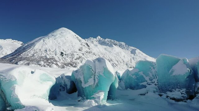 Aerial view of majestic glacier and snowy mountains in Chugach National Park, Valdez, Alaska, United States.