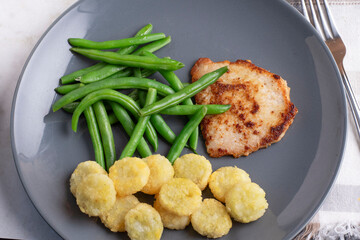 boneless pork chop with green beans and potato crowns