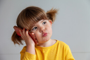 Happy toddler making a phone call, reflecting childhood and modern technology