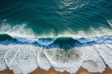 Fototapeta premium aerial view of a beach with waves crashing on the sand