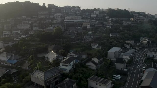 Aerial view of tenjin mountain and urban cityscape with homes and streets, Sasebo, Nagasaki, Japan.
