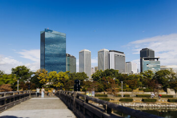 View of Osaka cityscape with Yodo River embankment and skyscrapers, Osaka prefecture, Japan, in a sunny day with a blue sky, streets of Osaka downtown center, travel to Japan