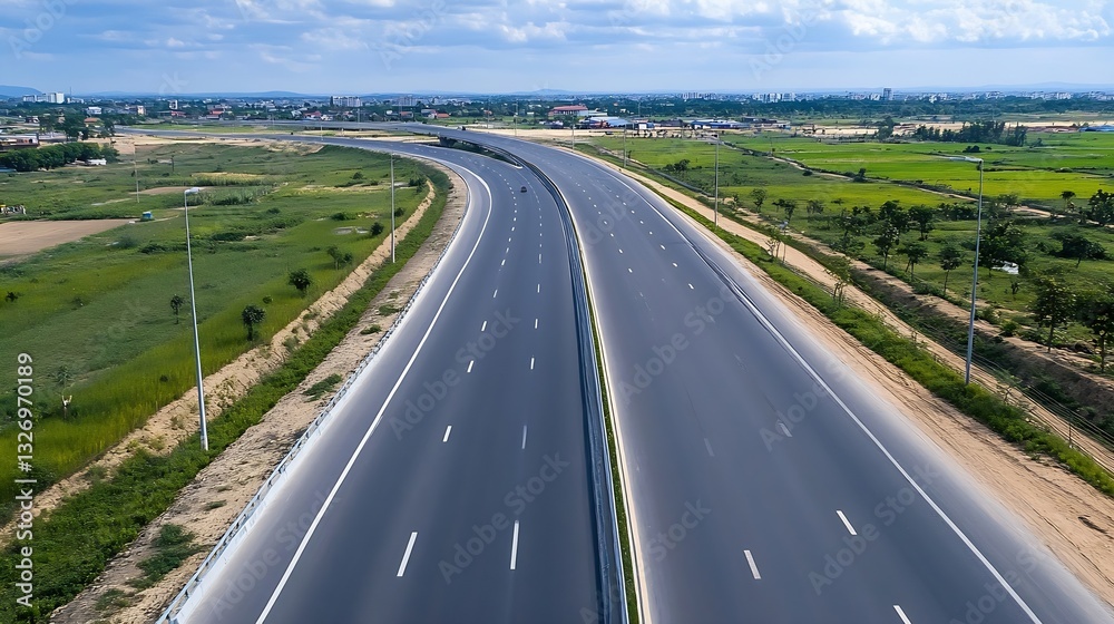Aufkleber aerial view of a beautifully designed highway surrounded by lush green fields under a clear blue sky