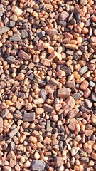 A textured background of small stones, perfect for adding a natural, rustic, or minimalist touch to your designs. Ideal for themes like nature, construction, or earthy aesthetics
