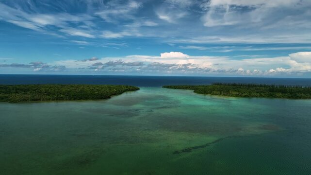 Aerial view of beautiful green islands surrounded by tranquil ocean and coral reef, Goro, South Province, New Caledonia.