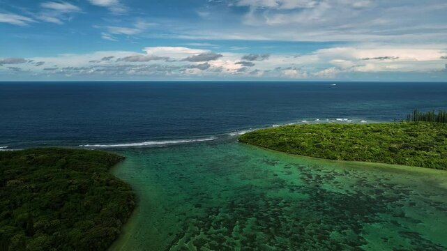 Aerial view of serene and picturesque tropical islands with clear water and vibrant reef system, Goro, South Province, New Caledonia.
