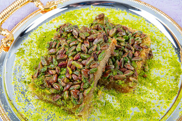 Pistachio kadayif.Kadayif dessert with syrup, whole pistachios on top, sliced ​​grated yufka on...