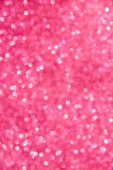 A soft pink bokeh-style background with unfocused light creates an elegant space for text or design elements.