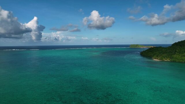 Aerial view of a beautiful tropical island with a serene reef and clear blue ocean, Satitoa, Atua, Samoa.