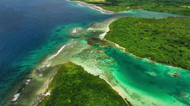 Aerial view of beautiful tropical beach with turquoise water, reefs, and lush palms, Port Vila, Shefa, Vanuatu.