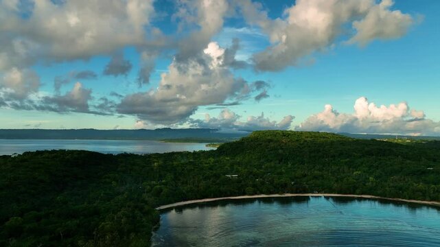 Aerial view of a moody sunset over the ocean and bay with lush greenery and clouds, Port Vila, Shefa, Vanuatu.