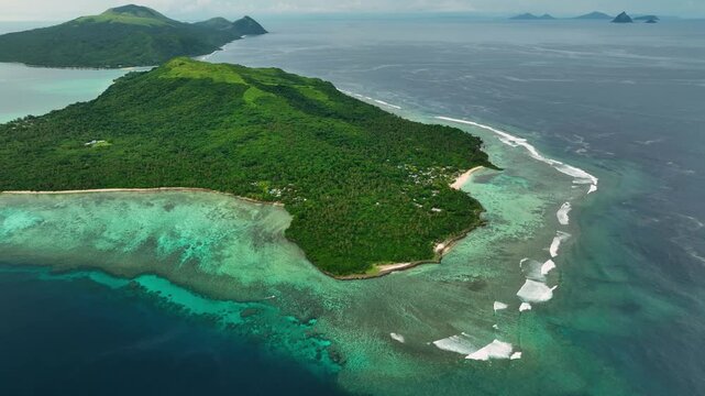 Aerial view of beautiful tropical beach with turquoise water, reef, and palms, Port Vila, Shefa, Vanuatu.