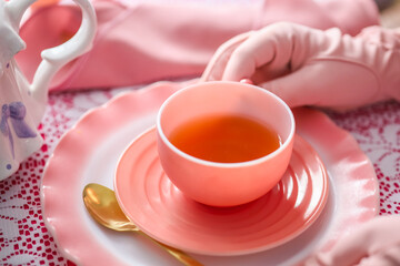 A pink antique tea cup, at a tea party 