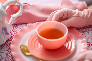 A pink antique tea cup, at a tea party 