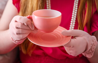 A pink antique tea cup, at a tea party 