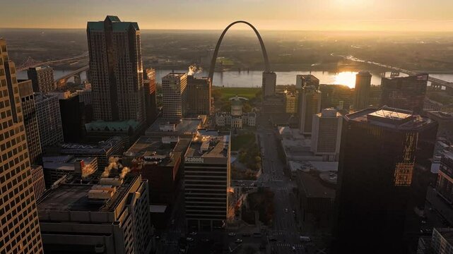 Aerial view of downtown St. Louis featuring the iconic Gateway Arch, Old Courthouse, and Peabody Plaza at sunset, St. Louis, Missouri, United States.