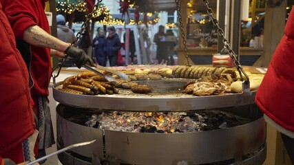 Hot food on open fire stall in Gendarmenmarkt at Christmas in daytime, Mitte, Berlin, Germany