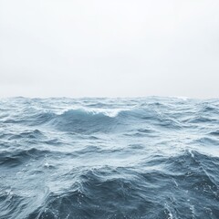 Obraz premium Serene expanse of ocean waves under a misty sky capturing the vastness of the sea and the beauty of nature