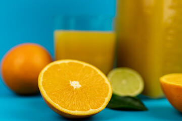 Half an orange on a blue background. Close-up view from above. Orange background
