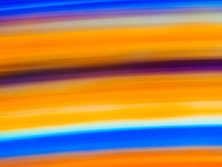 Swirling hues of blue and orange create a vibrant abstract landscape at twilight