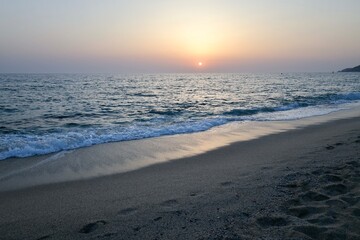 Sunset ocean horizon, mountains on the horizon